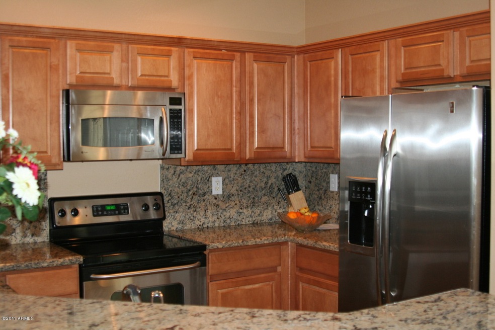 Slab Granite & Cinnamon Maple Cabinets