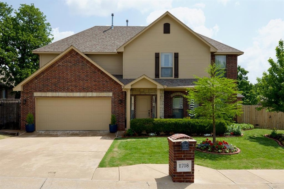 View of front of house featuring a front yard and a garage