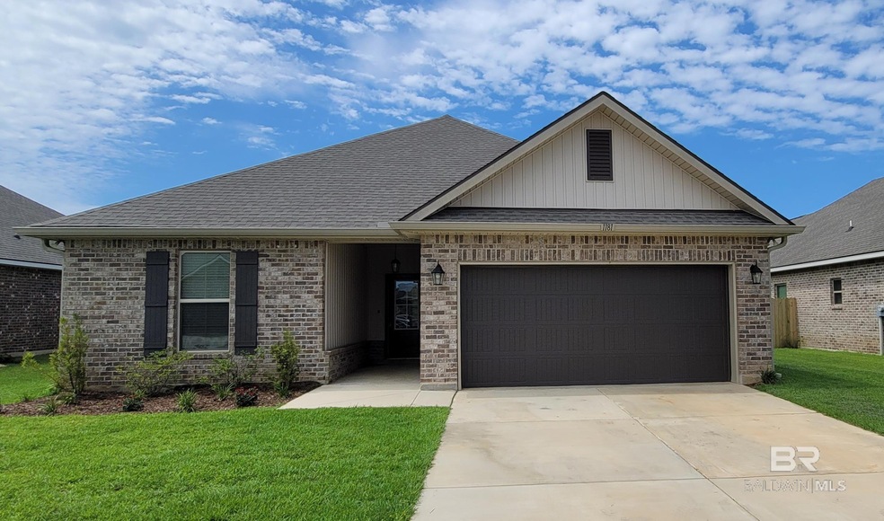 View of front of home with a garage and a front lawn