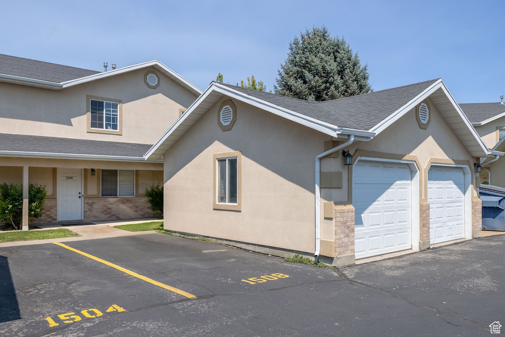 View of front of home featuring stucco siding, roof with shingles, and uncovered parking