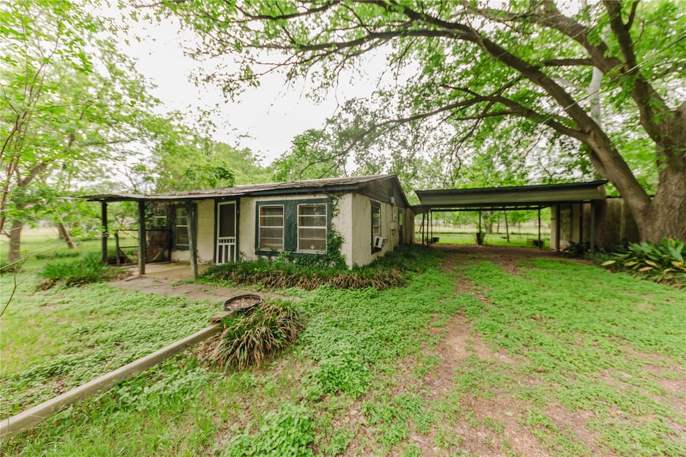 View of outbuilding with a carport