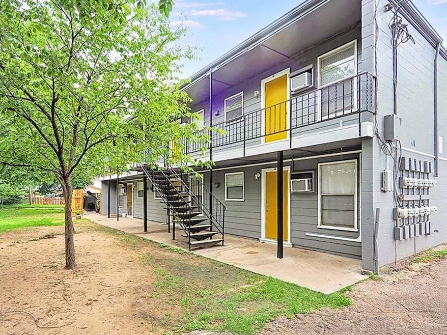 View of front of house featuring a patio, an AC w