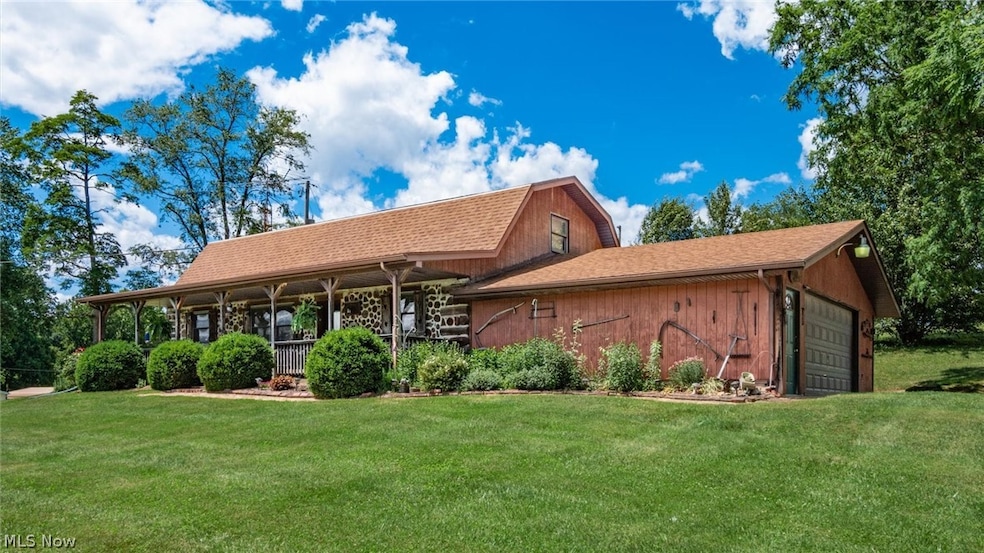 View of front facade featuring a front yard and a garage