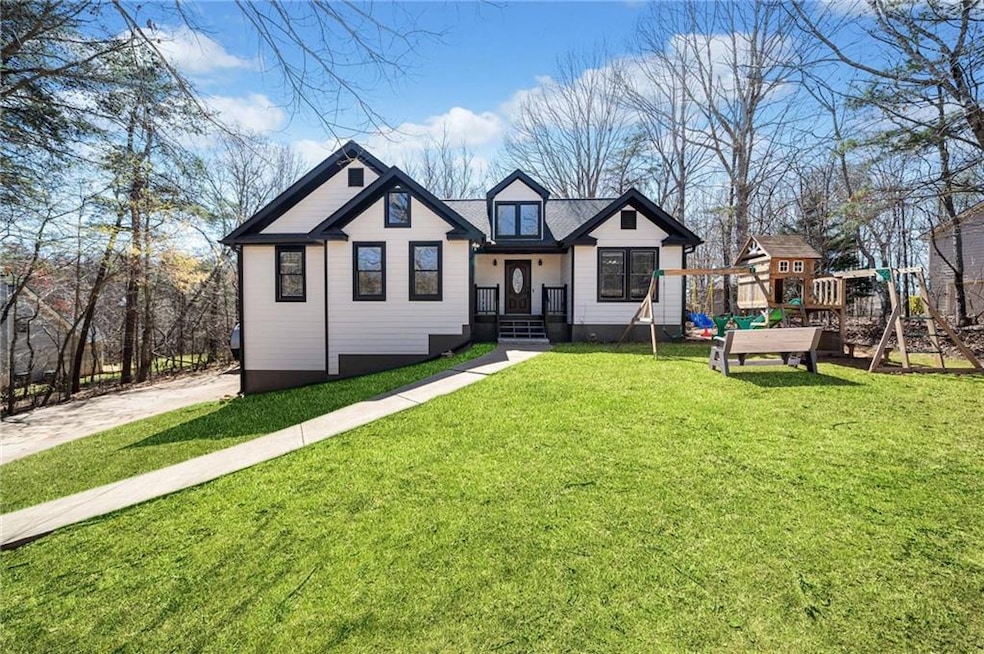 View of front of home with a front lawn and a play