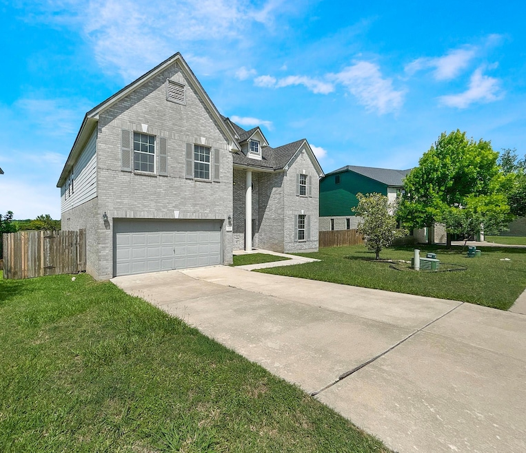 View of front of home featuring brick siding, a g