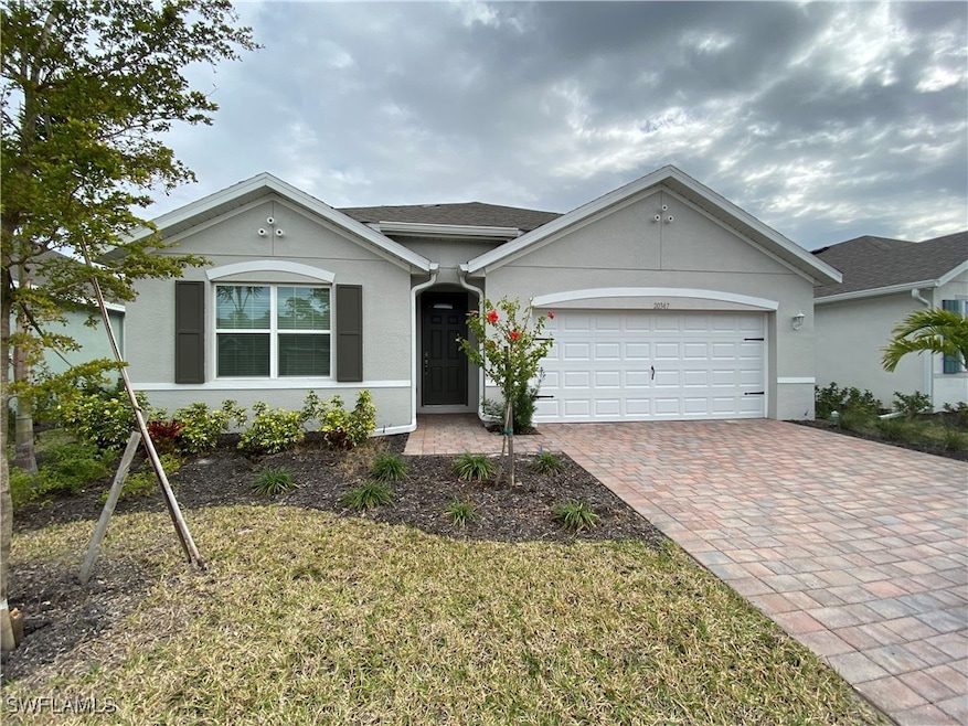 Ranch-style home with a garage and a front yard