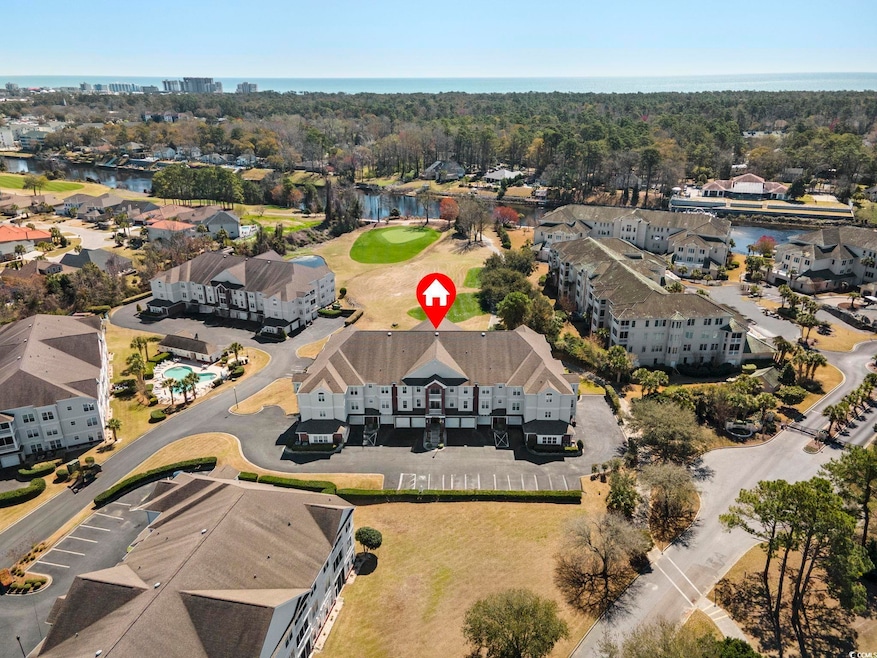 Building with a view of the waterway and golf course.