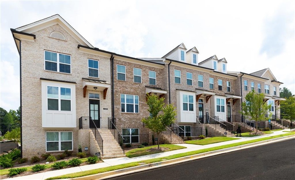 End Unit with beautiful front window entry door entering directly into the Kitchen level of townhome.  Photo of previously built Garwood Plan - meant for representation only