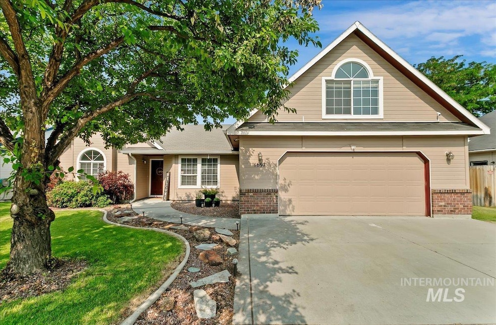 View of front of property featuring brick siding, driveway, and an attached garage