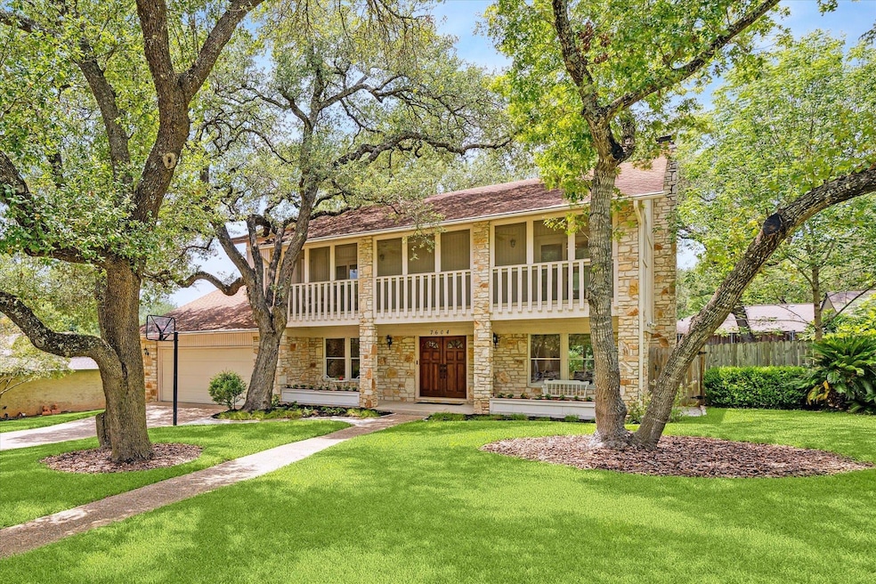 View of front facade with stone siding, covered p