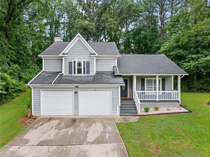 View of front of property with a garage, a front l