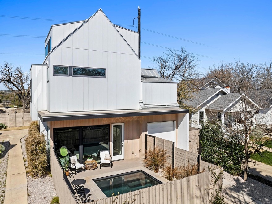 Rear view of house featuring metal roof, a standi
