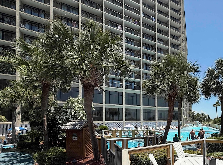 View of apartment building / complex featuring a community pool