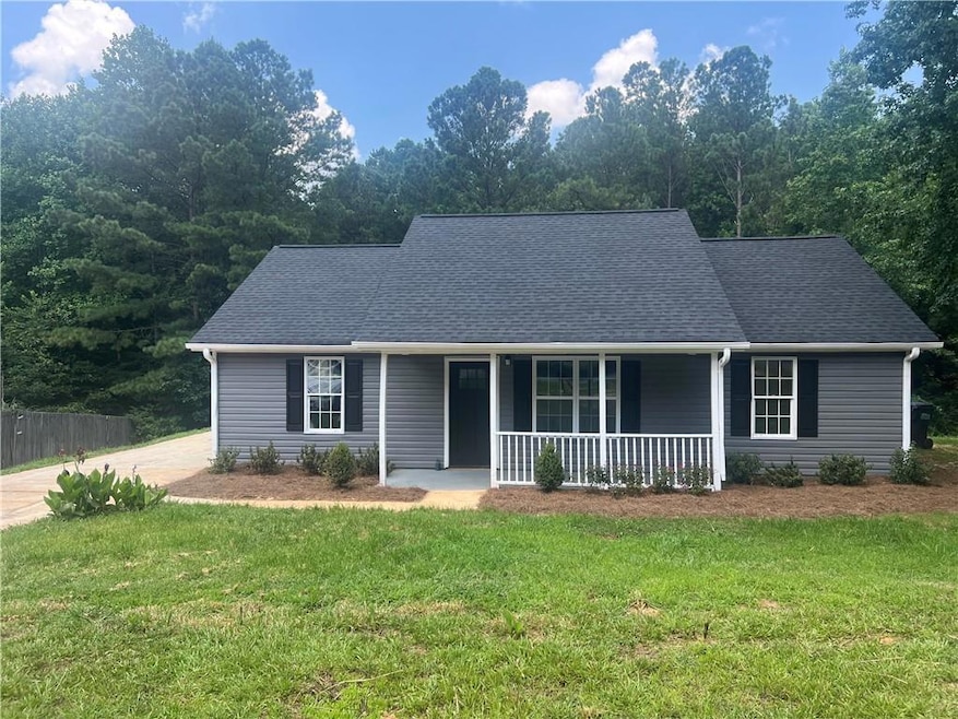 Ranch-style home featuring a porch and a shingled roof