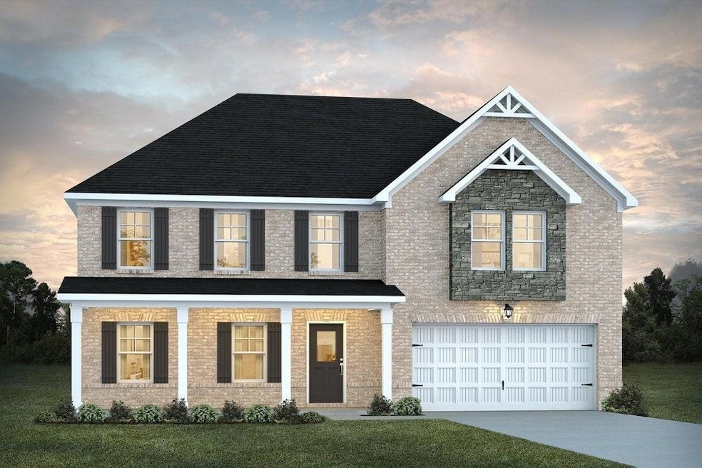 View of front of property with a garage, a yard, and driveway