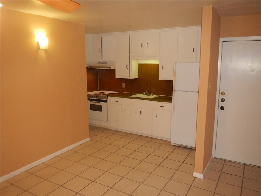 Kitchen featuring white appliances, under cabinet