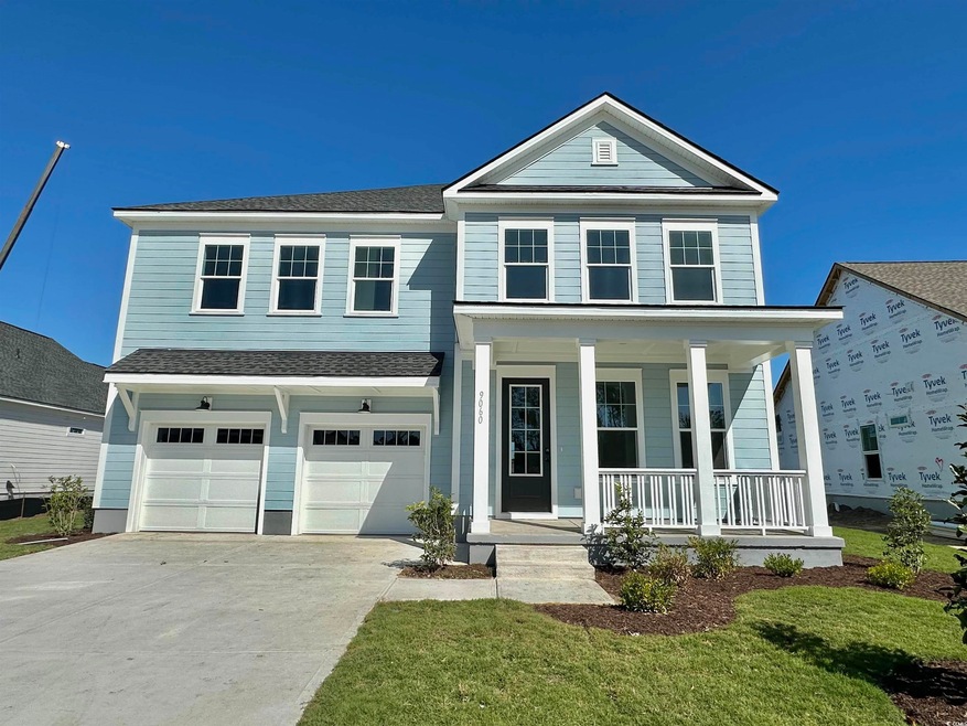 View of front of home featuring a front lawn, cove