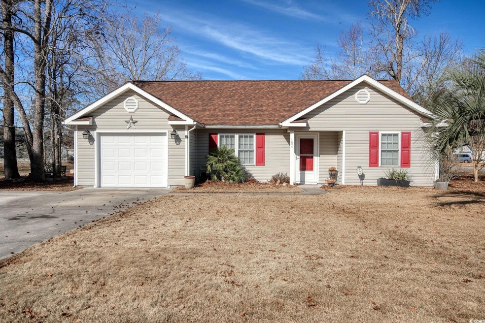 Ranch-style house featuring a front yard and a gar