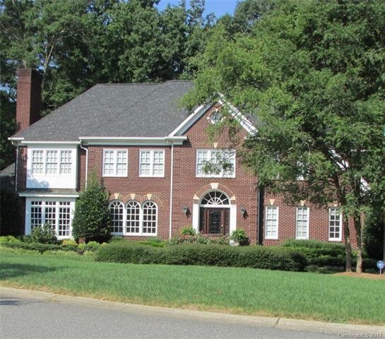 This brick home has a circular drive in the front.
