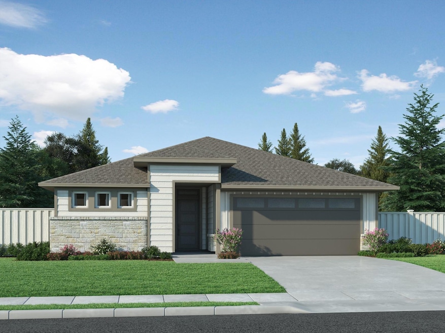 Prairie-style home featuring driveway, stone sidi