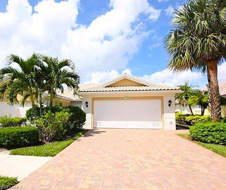 Mediterranean / spanish-style house featuring a ga