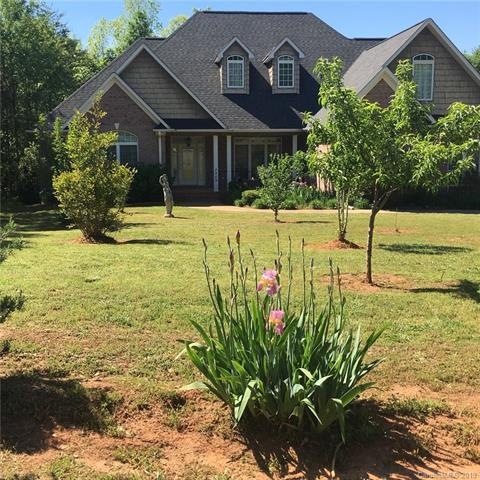 Front view with beautiful fruit trees and flowers.