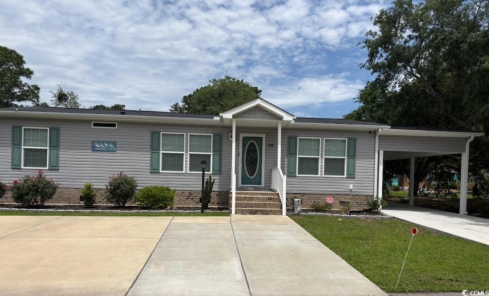 View of front of property with a carport and a fro