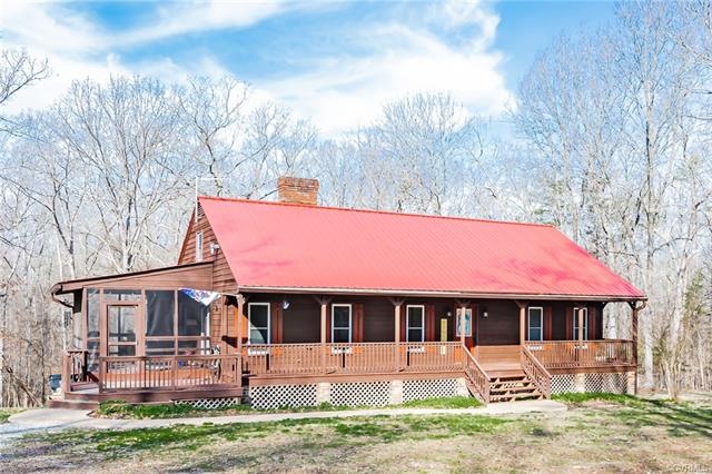 Cedar siding, stained about 2 years ago. Red metal roof.