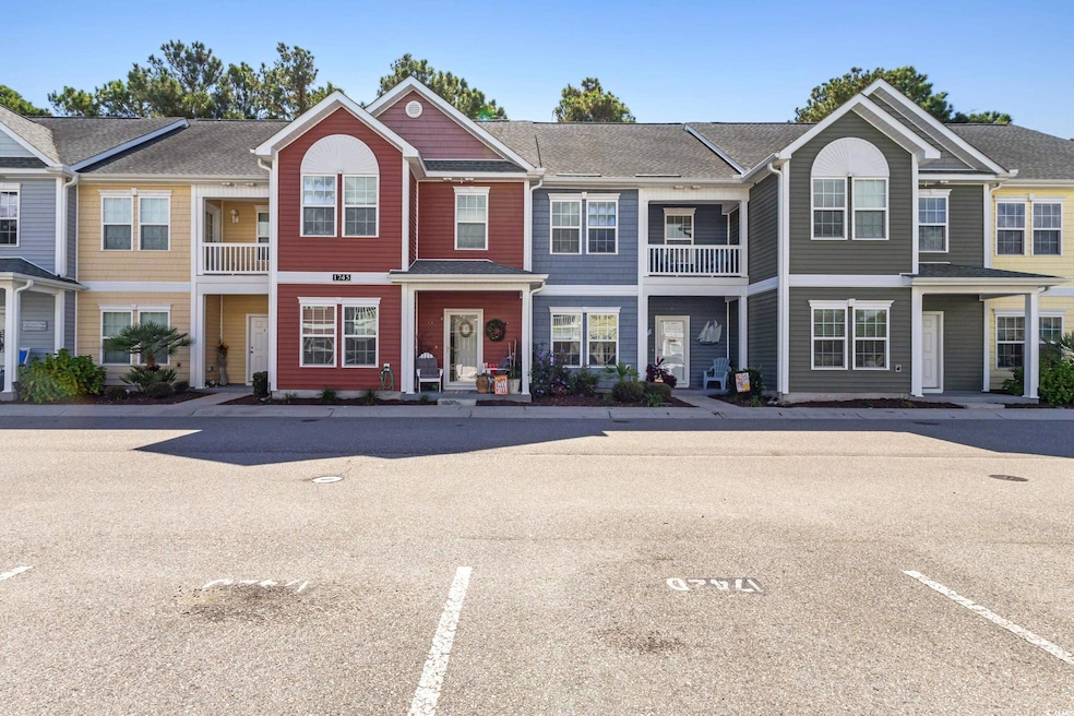 Traditional home with a residential view, uncovered parking, a balcony, and a shingled roof