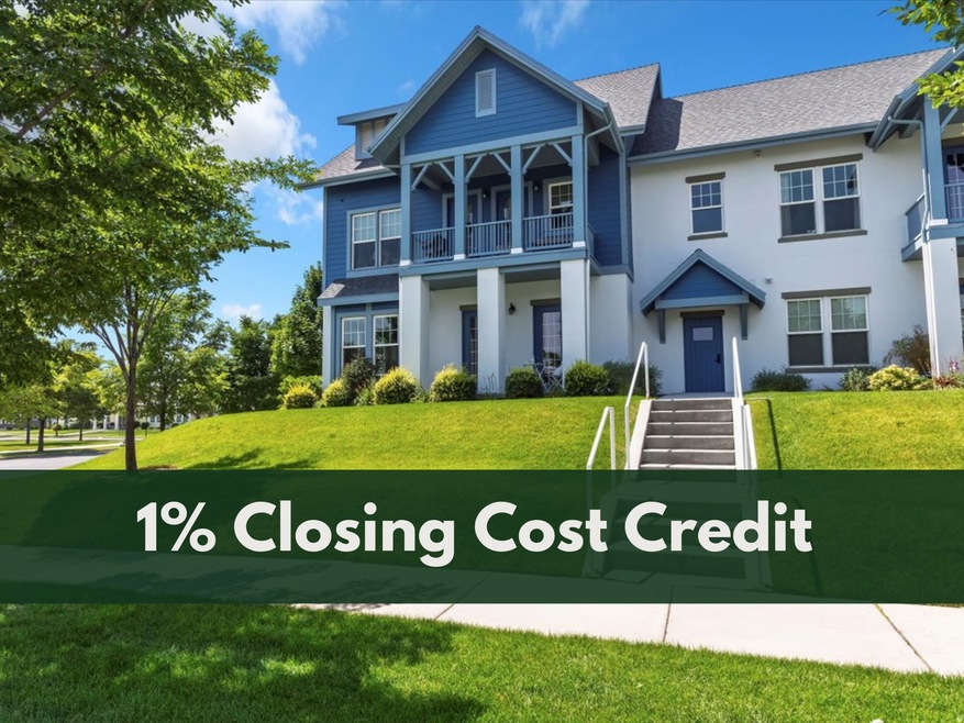 View of front of property featuring a front lawn, a covered patio, stucco siding, and a shingled roof