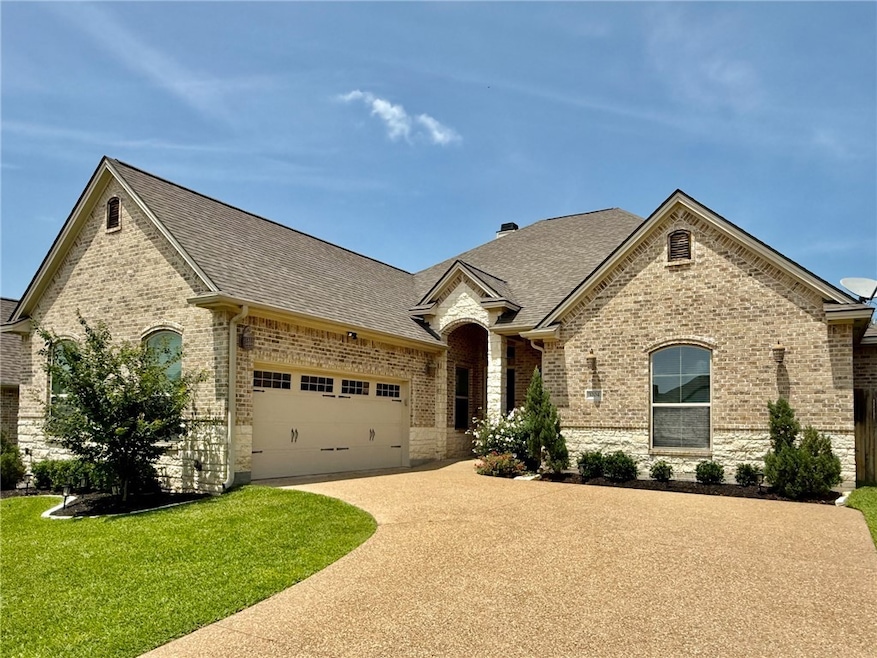 French country home featuring concrete driveway, a