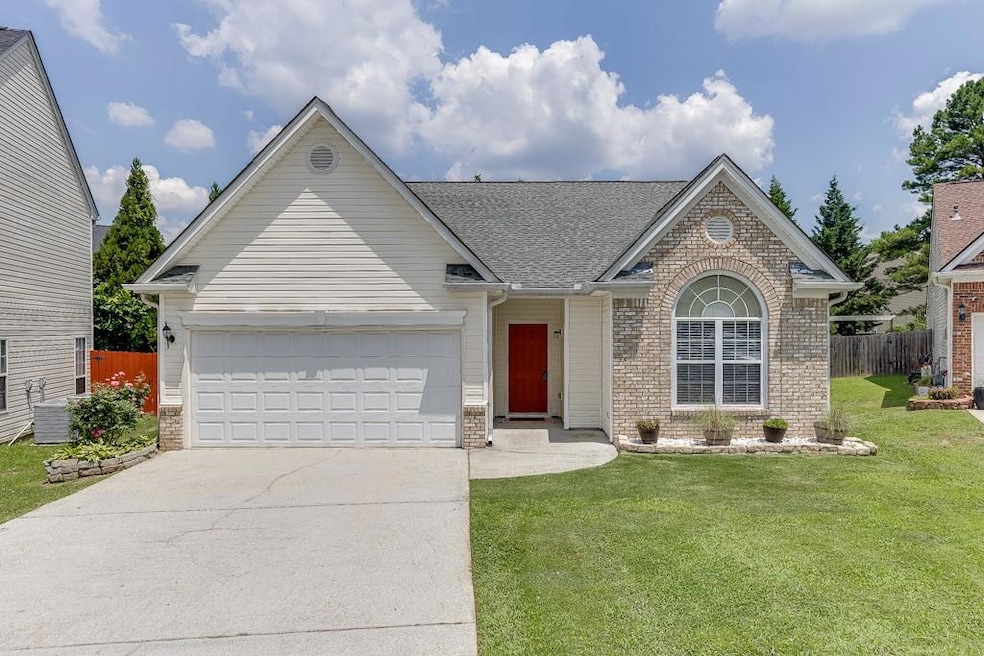 View of front of property with concrete driveway, a garage, brick siding, and a shingled roof