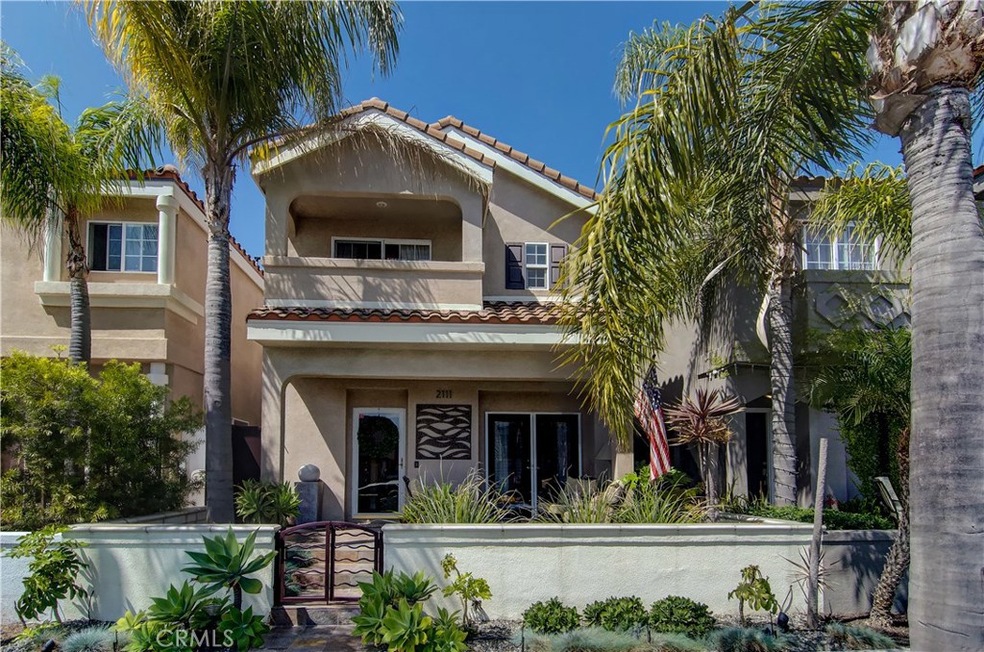 Southern California style with classic Mediterrean details, palms and artistic gates to entry courtyard.