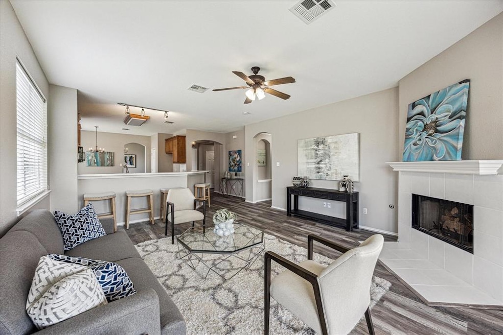 Living area featuring a tile fireplace, a ceiling