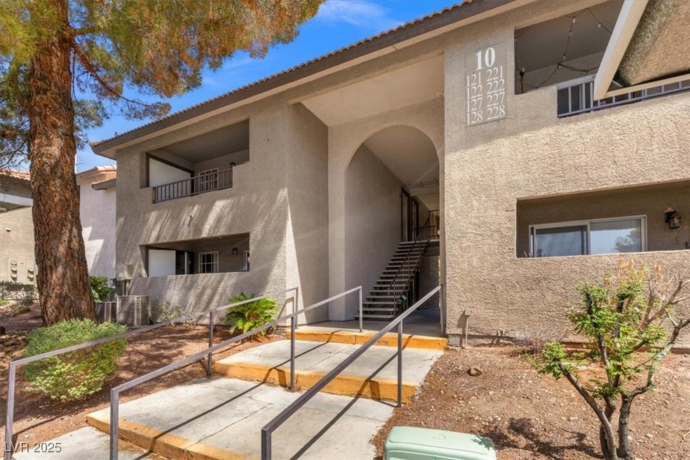 Entrance to property with stucco siding, a patio a