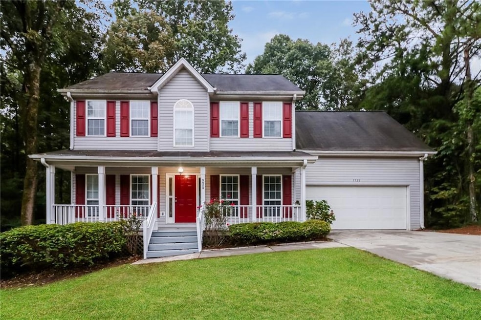 Colonial-style house with a garage, a porch, and a