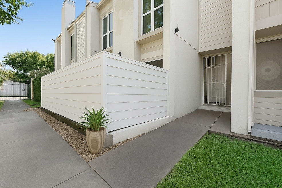 Private gated front entry and enclosed patio create a welcoming, secure first impression in this quiet Galleria-area community (virtually staged).
