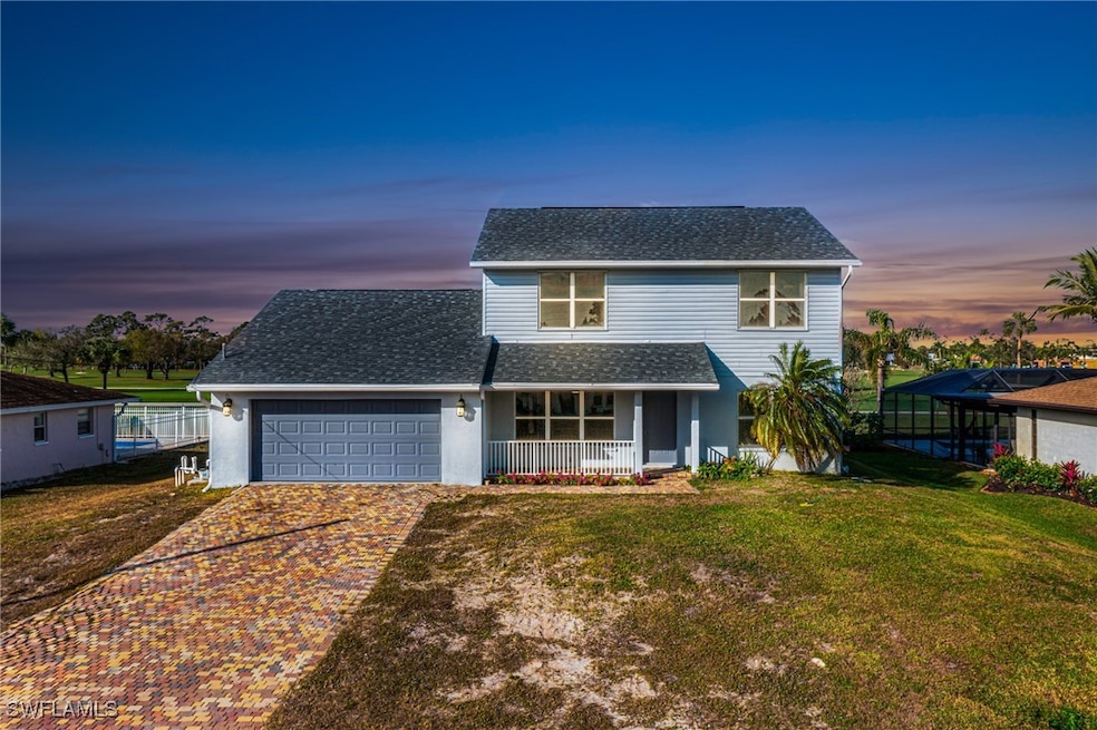 View of front property with a porch, a yard, and a