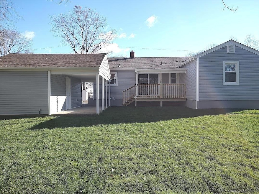 View from rear yard showing concrete patio and dec