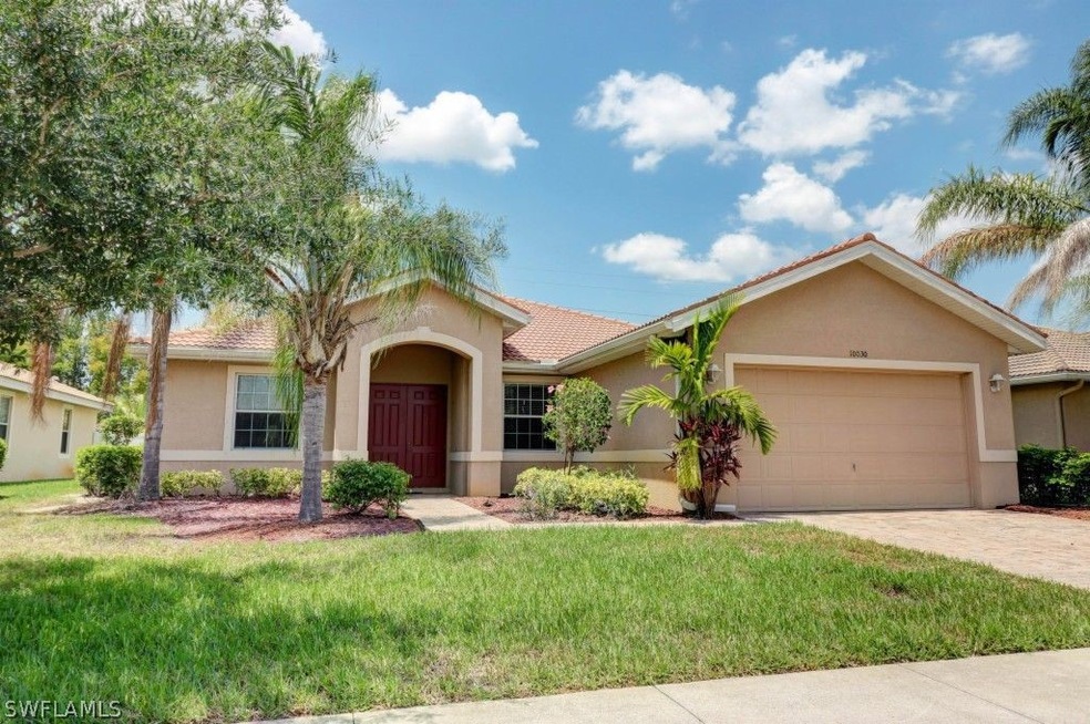Beautiful front elevation featuring tile roof, cov