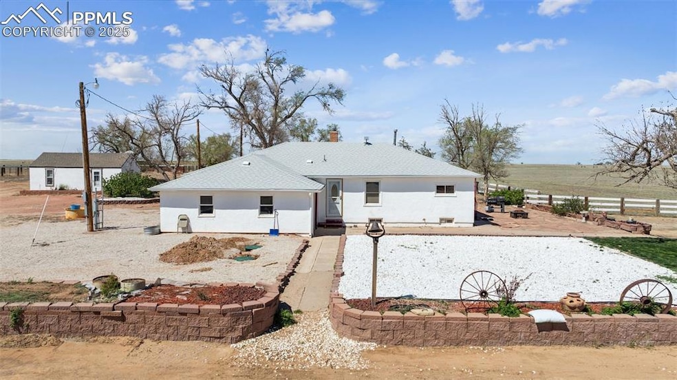 Rear view of property featuring stucco siding and 