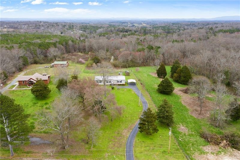 Nestled on FIVE acres with a paved driveway, carpo