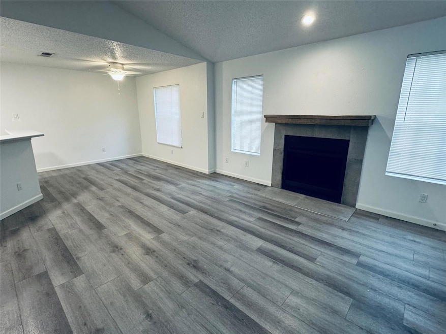 Unfurnished living room with ceiling fan, a textu