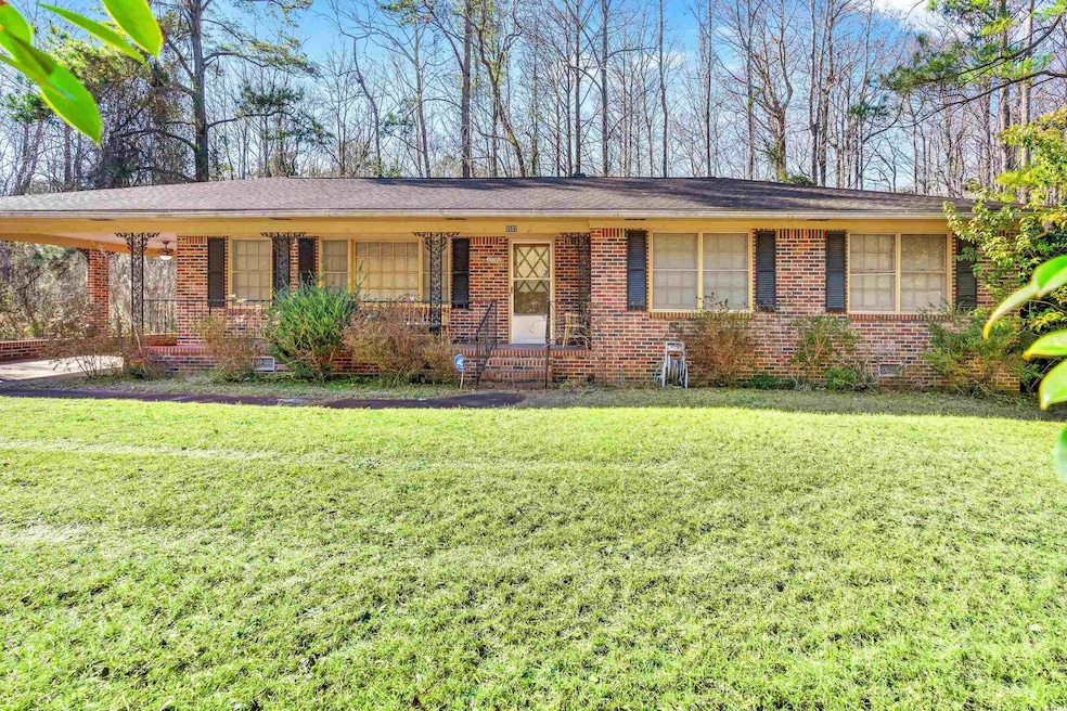 Ranch-style home featuring an attached carport, br