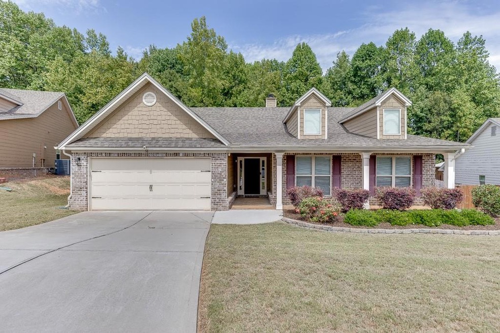 View of front of home with a garage, a front lawn,