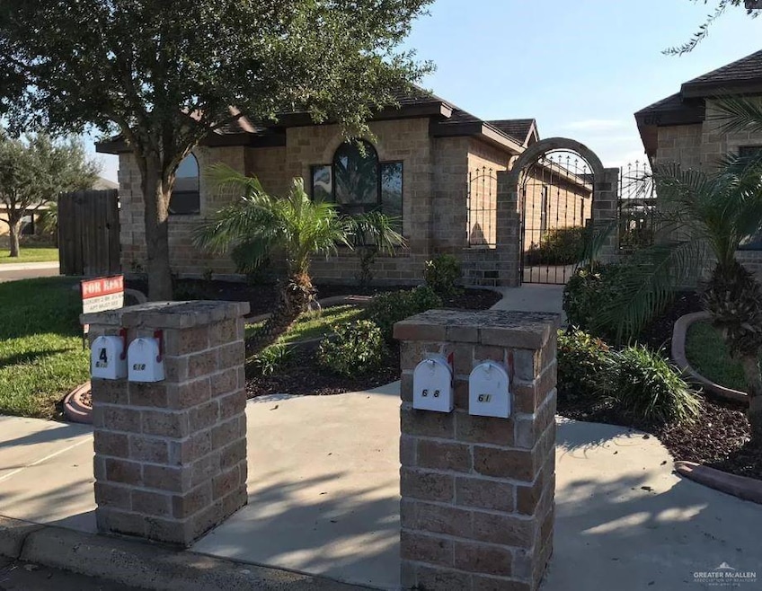 View of front of home featuring a gate and a patio area