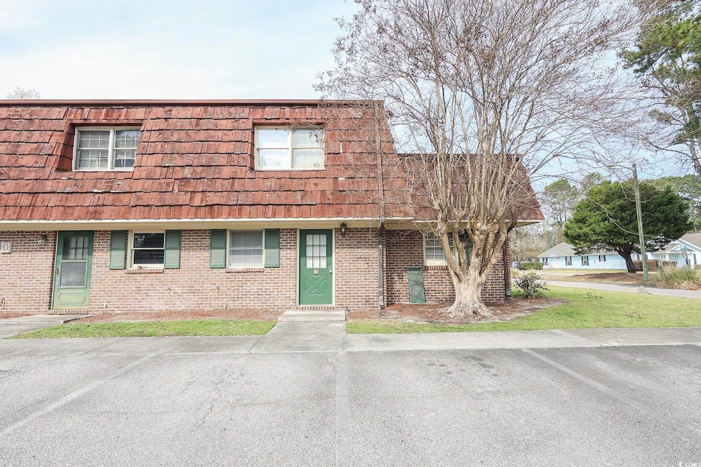 Townhome / multi-family property with brick siding