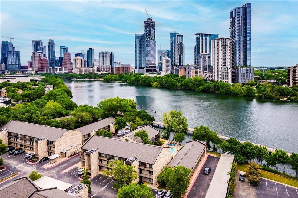 Birds eye view of property with a water view and 