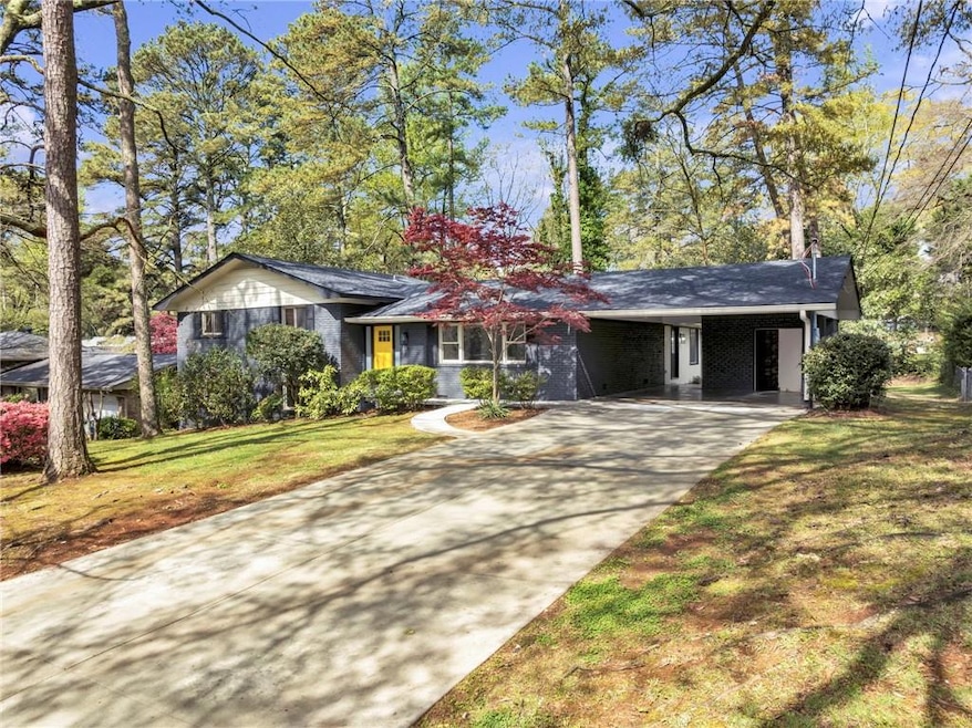 Single story home featuring a carport and a front 