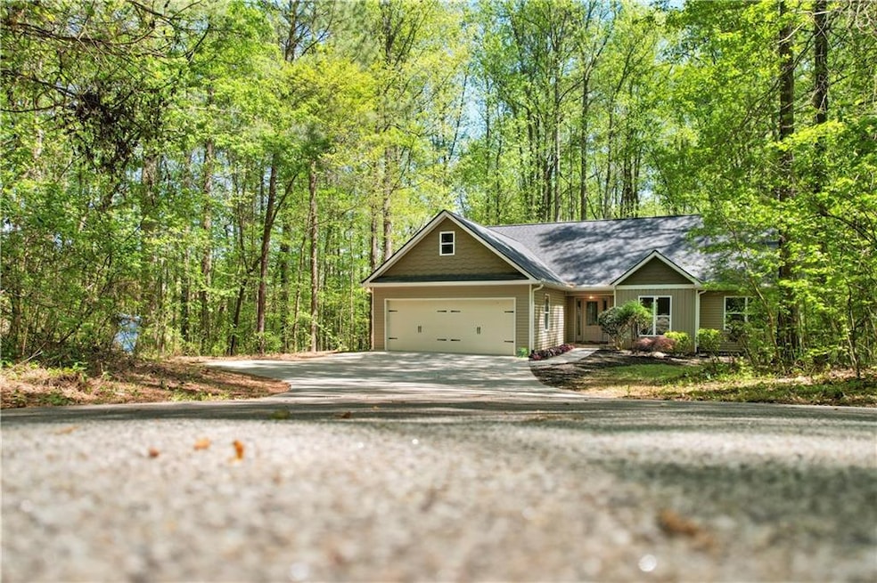 View of front facade featuring driveway and an attached garage